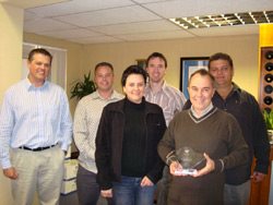 Pictured from left: Carl Woodland, COO Oasys Exhibitions, Craig Andrew, Key Account Manager Oasys Exhibitions, Sanet Delport, Project Manager Momentum McCann, Henry Jacobs, Oasys Exhibitions Design Manager, Wayne Parry, MD Momentum McCann holding the symbol of partnership between the two companies, and Kevin Hughes, COO Oasys Electrical.