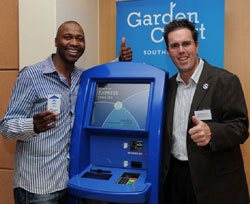Lucas Radebe and Graham Wood, MD, Southern Sun Hotels, at the launch of what is believed to be Africa’s first self check-in kiosk, at the Garden Court, Sandton Cit, Joburg. (Image: Peter Morey)
