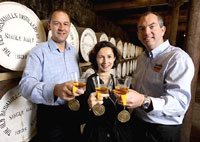 Voted Best in the World - Bushmills Global Brand Director Sarah Miles raises a glass of multi award-winning Bushmills Irish Whiskey with (l-r) Bushmills Distillery Supply Director, Gordon Donoghue and Bushmills Master Distiller, Colum Egan
