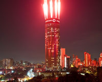 Press pack picture of Ponte City with fireworks for unveiling of Vodacom's new branding. On Friday night, 1 April 2011, only half of the Ponte LED sign was lit up. See also  by Darren Smith, which was taken on Friday night.