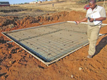 S’celo Shange of SRK checking a foundation slab.