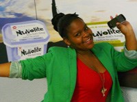 Keneiloe Makgalemele of Tsutusmane village in Alexandra, and who attends Sandown High School, receives her Blackberry handset in the Nuvolite “Dream Wall” competition from Clinton Scriven, a representative of the Willowton Group, producers of Nuvolite medium fat spreads.