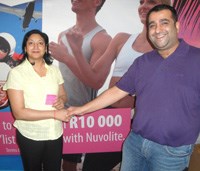 Tsholofelo Mashitisho of Northgate receives her prize of a R10,000 treadmill in the Nuvolite “Dream Wall” competition.