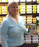 Anna-Marie Ross of Sanddrift in Milnerton receives her prize of a R10,000 grocery voucher in the Nuvolite “Dream Wall” competition from Nuvolite.