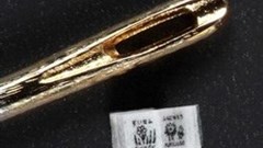 This picture released by Japan's printing giant Toppan Printing shows the printed book entitled &quot;Shiki no Kusabana&quot; (flowers of seasons) next to a needle eye for comparison. (Image: Copyright 2013 Printing Museum,Tokyo, TOPPAN PRINTING CO, LTD)