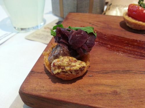 Beef rump steak on potato rosti with onion marmalade, whole grain mustard and wild rocket