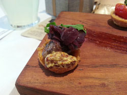 Beef rump steak on potato rosti with onion marmalade, whole grain mustard and wild rocket