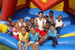 PR Officer Thanusha Pillay playing on the jumping castle with some of the children from the Missionvale Care Centre.