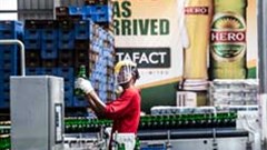 An employee at the Onitsha brewery in Nigeria checks a batch of beer. Image: SABMiller