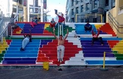 Teens from the Lalela Project paint the stairs at the VA Waterfront's Clock Tower precinct