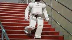The ASIMO robot built by Honda, walks downstairs to a glittering event in Manhattan. Image: