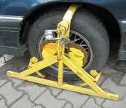 Wheel clamps may be used in centres where able-bodied people illegally park in disabled bays. Alternatively, the vehicle may be towed away. Image: Wikipedia