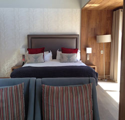 A modern room with all you could ask for – everything from a desktop computer and giant TV set to a Nespresso machine.