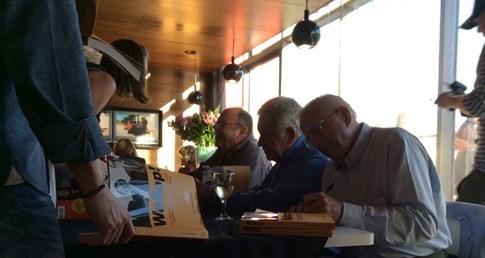 Rightford, Searle-Tripp and Makin signing Wallop! copies for book launch attendees