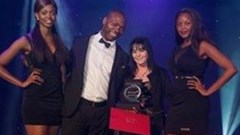 Angela Dick receives the Outstanding Woman in Business Award from Buyani Zwane, Founder and CEO of Breakthrough Development. [Image: Julian Cole.]