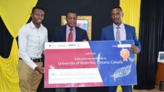 Norman Muga and Mburu Njunge pose for a photo with principal secretary Ministry of Information and Communication Dr. Victor Kyalo when they received their prize.