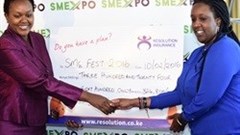 Wanjiku Gitau ,Senior Marketing Executive Resolution Insurance presenting a sponsorship cheque for the SMEFest 2016 to Dorcas Muthoni, the lead organiser of the SME expo. Courtesy/ East African Press Service, Nairobi