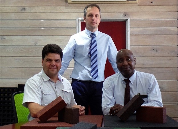 Seated left is Jaco Snyman, Envirobuild managing director, standing Mehran Zarrebini, Van Dyck Carpets head and right is Vusimuzi Mathe, Mathe Group director
