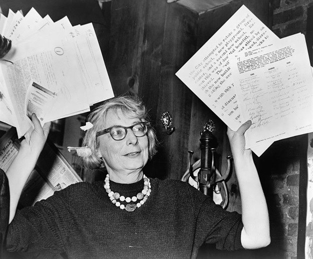 Jane Jacobs holds up documentary evidence at a 1961 press conference during the campaign to save the West Village.