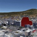The proposed development with the Bo-Kaap neighborhood and Signal Hill behind it. Image source: