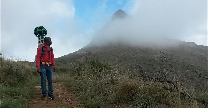 Volunteer trekker Rendani Mudau of SANPARKs glances back at Lion's Head during a #TrekSouthAfrica hike in Cape Town in May 2016. - Photo: Grant Clark