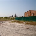 Eight years after a commitment to build houses there, the Thembokwezi site in Khayelitsha is still empty. Photo: Ashraf Hendricks