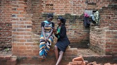 Ugandan youth researcher Sarah Bafumda (right) shares information from the research with Hamidah Nyanzi, a respondent in the study.