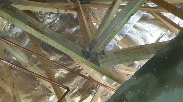 A 45-degree truss hanger not installed and a 90-degree hanger not completely nailed.