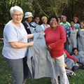 Adéle’s Mohair near Fish River Mouth has been providing employment for rural communities for over 30 years. Here founder and Agri EC Adéle Cutten (left) and long-time employee Liz Dyakala (right) inspect the team’s new uniforms. (Image: Supplied)