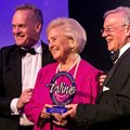 May de Lencquesaing holding her IWC Lifetime Achievement Award, flanked by Tim Atkin (left) and Charles Metcalfe (right)