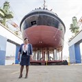 Lady Sponsor of the Usiba tug, Judith Nzimande, with the new tug which will serve at the Port of Richards Bay.