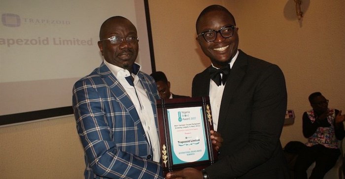 Centrespread Grey receives award.