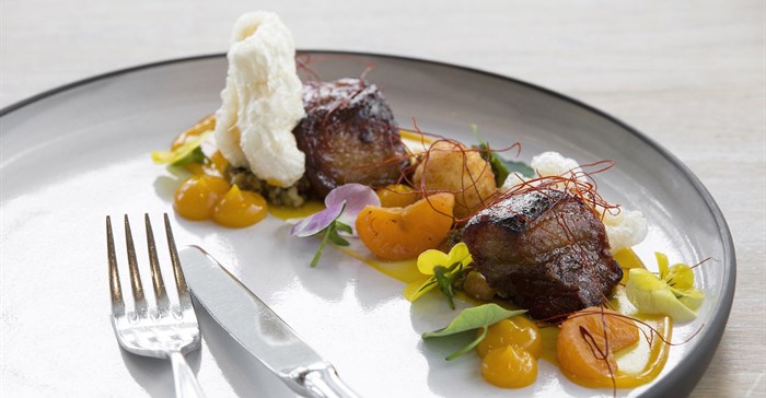 Cavalli dish by Michael Deg: Slow-cooked pork cheek, cooked in master stock, pickled naartjie, chilli, pesto, goats cheese croquette, crackling