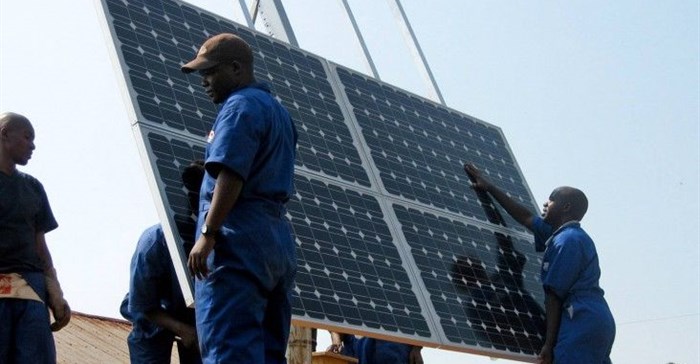 Training workers to properly install solar panels at health clinics in Rwanda provides clean energy and creates green jobs. Photo: Walt Ratterman, Sunepi