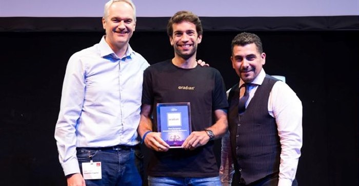 Oradian co-founder Julian Oehrlein on stage at the European FinTech event in Brussels accepting the award for Europe's Most Innovative Banking Software.