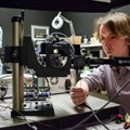 Stanford researchers David Lindell (left) and Matt O’Toole work on a laser-based system that can detect hidden objects around corners (Credit: L.A. Cicero)