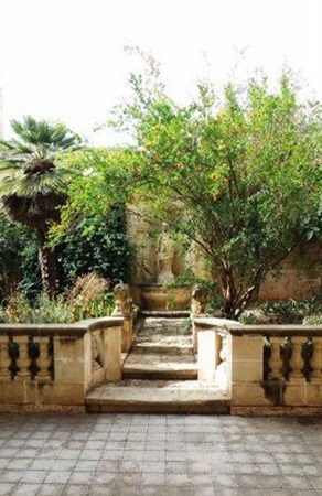 The Lace House garden with nymphaeum framed by overhanging pomegranate tree | Mark Leach