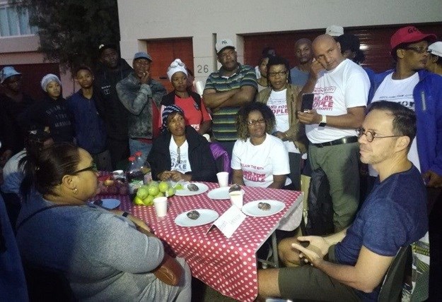 Cape Town mayco member Brett Herron discussing emergency housing with picketers outside his home in Newlands last week. Photo: Barbara Maregele