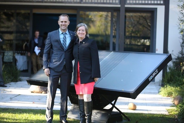 Cody Friesen, Zero Mass Water CEO stands with US consul general Virginia Blaser in front of an array of Source Hydropanels