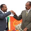 Ethiopian Prime Minister Abiy Ahmed, left, and Eritrean President Isaias Afwerki celebrate the reopening of the Embassy of Eritrea in Addis Ababa on July 16. An Ethiopian news crew was attacked and their driver killed while traveling to the capital to cover the visit. Credit: AFP/Michael Tewelde.