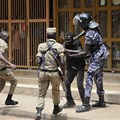 Security forces detain a protester in Kampala on August 20. Security personnel beat and detained at least four journalists who were covering unrest in Uganda's capital. Credit: AP/Ronald Kabuubi/CPJ.