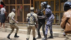 Security forces detain a protester in Kampala on August 20. Security personnel beat and detained at least four journalists who were covering unrest in Uganda's capital. Credit: AP/Ronald Kabuubi/CPJ.