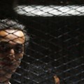 Egyptian photojournalist Mahmoud Abu Zeid, also known as Shawkan, looks on behind bars in his trial on the outskirts of Cairo, Egypt, on May 31, 2016. Shawkan was sentenced to five years in prison on September 8, 2018. Credit: Reuters/Amr Abdallah Dalsh/CPJ.