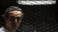 Egyptian photojournalist Mahmoud Abu Zeid, also known as Shawkan, looks on behind bars in his trial on the outskirts of Cairo, Egypt, on May 31, 2016. Shawkan was sentenced to five years in prison on September 8, 2018. Credit: Reuters/Amr Abdallah Dalsh/CPJ.