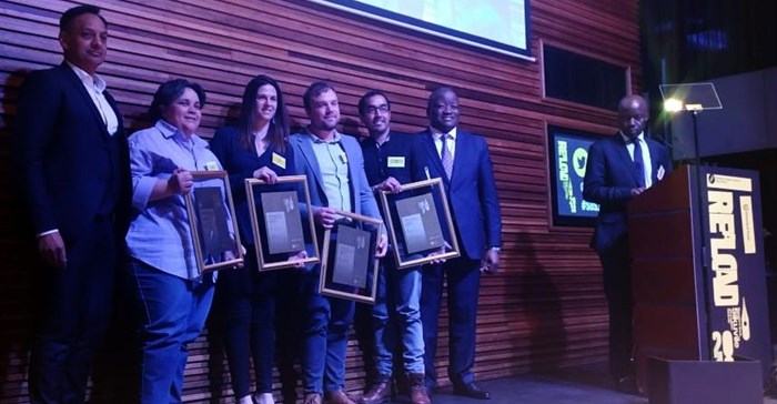 The 2018 Standard Bank Sikuvile Journalism Awards' investigative journalism and story of the year winners on stage.