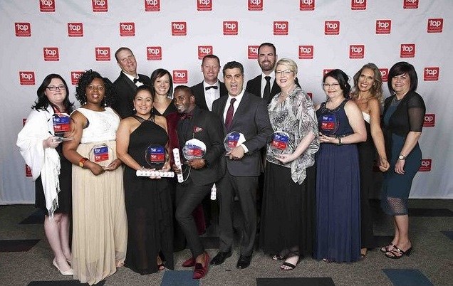 DHL Express representatives showcase some of their awards during the event.