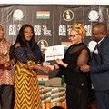 Matlou Tsotetsi, director, Brand Communication, presenting the certificate of AFRIMA Host Country to Ghana Minister Catherine Afeku, Ministry of Tourism, Arts & Culture.