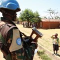 A Congolese child saluting a MONUSCO peacekeeper. Abel Kavanagh/Wikimedia Commons, CC BY-SA