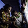 Late voters check a list in a school in Kinshasa on December 30, during Democratic Republic of Congo's general elections. Authorities have cut internet access and blocked the signals to at least two news broadcasters while the results are counted. Credit: CPJ: AFP/Luis Tato.