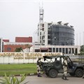 Gabonese soldiers stand in front of the headquarters of the national broadcaster in Libreville on January 7, 2019, after a failed coup. Gabon shut down the internet and broadcasting services following the coup attempt. Credit: CPJ/AFP/Steve Jordan.